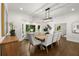 Elegant dining room featuring modern lighting, large windows, and a view of the backyard at 1260 Heards Ferry Rd, Sandy Springs, GA 30328