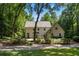 Beautiful home exterior with mature trees, lush landscaping, and a well-maintained lawn at 1260 Heards Ferry Rd, Sandy Springs, GA 30328