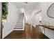 Bright foyer with hardwood floors, staircase, and view to an open doorway to another living space at 1260 Heards Ferry Rd, Sandy Springs, GA 30328