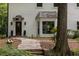 Detailed view of the home's front entrance with stone pathway, dark wood door and manicured landscaping at 1260 Heards Ferry Rd, Sandy Springs, GA 30328