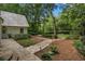 Beautifully landscaped front yard featuring stone pathway, mature trees, manicured shrubs, and outdoor lighting at 1260 Heards Ferry Rd, Sandy Springs, GA 30328