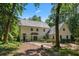 Charming two-story home with a light-colored exterior, well-maintained landscaping, and a winding stone walkway at 1260 Heards Ferry Rd, Sandy Springs, GA 30328