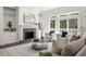 Well lit living room with built in cabinets, fireplace, hardwood floors and large windows at 1260 Heards Ferry Rd, Sandy Springs, GA 30328