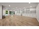 Large living room with hardwood floors, built-in shelving, and sliding glass doors at 1260 Heards Ferry Rd, Sandy Springs, GA 30328