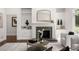 Well lit living room with built in cabinets, fireplace, hardwood floors and large windows at 1260 Heards Ferry Rd, Sandy Springs, GA 30328