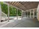 Covered patio with view of pool and wooded backyard, offering an ideal outdoor space at 1260 Heards Ferry Rd, Sandy Springs, GA 30328