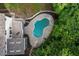 Aerial view of a backyard with a kidney-shaped pool, patio area, and lush landscaping at 1260 Heards Ferry Rd, Sandy Springs, GA 30328