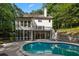 Backyard showcasing the kidney-shaped pool, patio, and white home exterior with a screened-in porch at 1260 Heards Ferry Rd, Sandy Springs, GA 30328