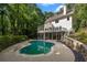 Beautiful backyard with a kidney-shaped pool, patio, and white home exterior surrounded by trees at 1260 Heards Ferry Rd, Sandy Springs, GA 30328