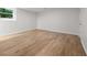 Bright room with wood floors, a large window, and a door leading to the backyard at 1260 Heards Ferry Rd, Sandy Springs, GA 30328