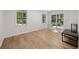 A room with wood floors, two windows, and a sliding glass door leading to the backyard at 1260 Heards Ferry Rd, Sandy Springs, GA 30328