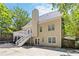 Backyard view featuring a deck with stairs and a well-maintained exterior, surrounded by trees at 1620 Concord Meadows Dr, Smyrna, GA 30082