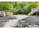 Expansive backyard area with a large concrete slab, grassy area and bordered by mature trees and foliage at 1620 Concord Meadows Dr, Smyrna, GA 30082