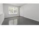 Room with large window, grey floors, and plenty of space at 1620 Concord Meadows Dr, Smyrna, GA 30082
