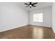 Bright bedroom with hardwood floors, large window, and ceiling fan at 1620 Concord Meadows Dr, Smyrna, GA 30082