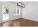Bright dining area with hardwood floors, modern lighting, and door to outdoor area at 1620 Concord Meadows Dr, Smyrna, GA 30082