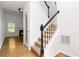 Bright entryway with hardwood floors, carpeted stairs, and view into the living room at 1620 Concord Meadows Dr, Smyrna, GA 30082