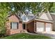 Traditional two-story brick home features attached two-car garage and lovely landscaping at 1620 Concord Meadows Dr, Smyrna, GA 30082