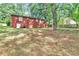 This backyard features a large brick home and a large grassy area at 5868 Ash St, Forest Park, GA 30297