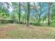 This backyard features a large grassy area and a fence, giving privacy from neighbors at 5868 Ash St, Forest Park, GA 30297