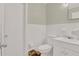Clean bathroom with white tiled walls, modern sink, and essential fixtures at 5868 Ash St, Forest Park, GA 30297