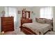 This bedroom features wood furniture, neutral walls, and natural light from the bright window at 5868 Ash St, Forest Park, GA 30297