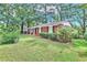 Charming one-story brick home with well-maintained lawn and mature trees at 5868 Ash St, Forest Park, GA 30297