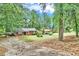 This exterior shows a home with a long driveway and multiple nearby trees at 5868 Ash St, Forest Park, GA 30297