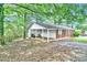 This home features a covered parking area and a covered front door to give refuge from the elements at 5868 Ash St, Forest Park, GA 30297