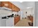 Practical kitchen with wooden cabinets, essential appliances, and an adjacent dining space at 5868 Ash St, Forest Park, GA 30297