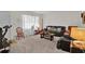 Bright living room with dark couches, neutral walls, and large window at 5868 Ash St, Forest Park, GA 30297