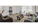 Spacious living room with plush seating, carpet, and abundant natural light at 5868 Ash St, Forest Park, GA 30297