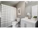 This bathroom has a shower with a striped curtain, a toilet and a modern vanity at 2015 Liberty Nw Ct, Atlanta, GA 30318