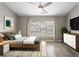 Bright bedroom featuring a large window, ceiling fan, and light-colored flooring at 2015 Liberty Nw Ct, Atlanta, GA 30318