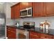 Close-up of a kitchen featuring stainless steel appliances and dark countertops at 2015 Liberty Nw Ct, Atlanta, GA 30318