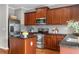 Modern kitchen featuring stainless steel appliances, dark wood cabinets, and granite countertops at 2015 Liberty Nw Ct, Atlanta, GA 30318