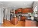 Well-equipped kitchen with stainless steel appliances, island, dark cabinets, and sleek granite counters at 2015 Liberty Nw Ct, Atlanta, GA 30318