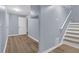 Finished basement with hard surface flooring, neutral paint and stairs to main floor at 2496 Shiloh Dr, Decatur, GA 30034