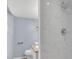Bathroom featuring shower with white marble-look tile and updated fixtures at 2496 Shiloh Dr, Decatur, GA 30034