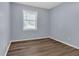 Empty bedroom featuring wood-look flooring, one window, and neutral paint at 2496 Shiloh Dr, Decatur, GA 30034