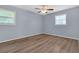 Bright bedroom with wood-look flooring, two windows and a neutral paint color at 2496 Shiloh Dr, Decatur, GA 30034