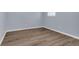Bedroom with light blue walls, white trim and wood-look vinyl flooring at 2496 Shiloh Dr, Decatur, GA 30034