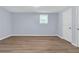 Bedroom with light blue walls, white trim and wood-look vinyl flooring at 2496 Shiloh Dr, Decatur, GA 30034
