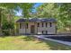 Charming home featuring a well maintained front yard, black roof, and brown trim at 2496 Shiloh Dr, Decatur, GA 30034