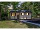 Charming home featuring a well maintained front yard, black roof, and brown trim at 2496 Shiloh Dr, Decatur, GA 30034