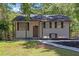 Charming home featuring a well maintained front yard, black roof, and brown trim at 2496 Shiloh Dr, Decatur, GA 30034