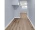 Hallway with light blue walls, white trim and wood-look vinyl flooring at 2496 Shiloh Dr, Decatur, GA 30034
