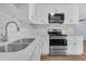 Bright kitchen featuring quartz countertops, stainless steel appliances and white cabinetry at 2496 Shiloh Dr, Decatur, GA 30034