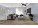 Light and airy living room featuring a gray sofa, neutral color scheme, and ceiling fan at 2496 Shiloh Dr, Decatur, GA 30034