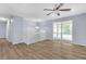 Inviting living room with hardwood floors, a large window, and access to a staircase at 2496 Shiloh Dr, Decatur, GA 30034